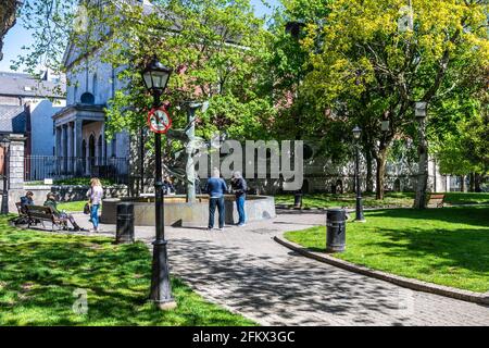 Cork, Ireland. 4th May, 2021. Cork basked in sunshine today, albeit with strong winds. Bishop Lucey Park in Cork City Centre was busy with people enjoying the sunshine. Credit: AG News/Alamy Live News Stock Photo