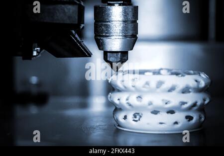 3d printer printing objects blue gray color form closeup. Stock Photo