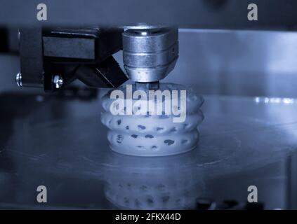 3D printer prints bkue gray form figure close Stock Photo