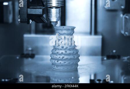 3D printer prints from the plastic figure closeup. Stock Photo