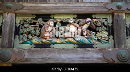 Sanzaru or Three Wise Monkeys, a wooden pictorial maxim at Toshogu Shinto Shrine in Nikko, Japan. See no evil, hear no evil, speak no evil. Stock Photo