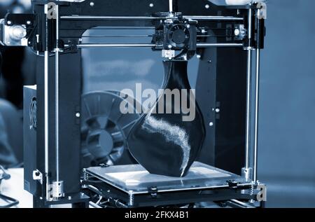 3D printer printing a model in the form of black vase close-up. Stock Photo