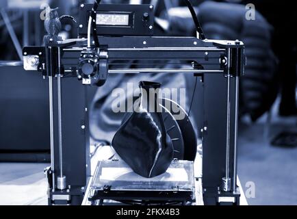 3D printer printing a model in the form of black vase close-up. Stock Photo