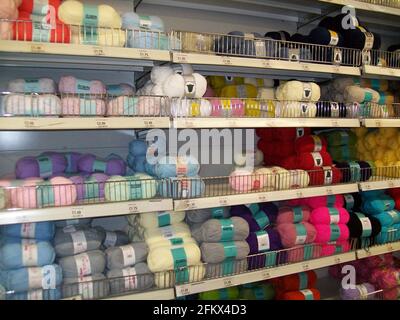 Different coloured balls of wool on a supermarket shelf Stock Photo