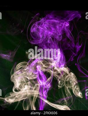 Abstract colorful smoke against a black background Stock Photo