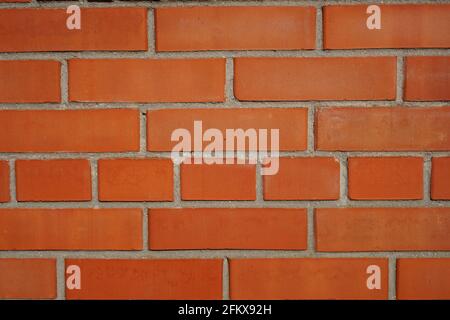 Background part of orange brick wall with grey seams. Stock Photo
