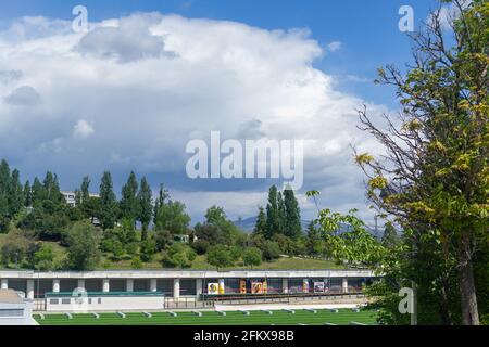 Madrid park with clouds of evolution and field full of plants and flowers, Community of Madrid, in Spain. Horizontal photography. Stock Photo