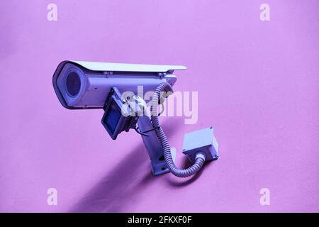 security camera on pink background - Surveillance Cameras Stock Photo