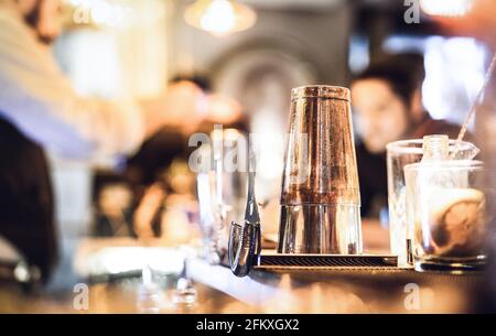 Blurred defocused side view of barman preparing drink to guest at speakeasy cocktail bar - Social gathering concept with people enjoying time together Stock Photo