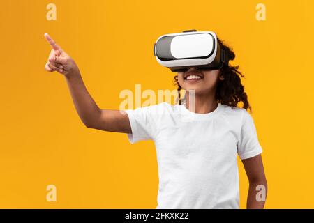 African American Girl Wearing Virtual Reality Glasses Stock Photo