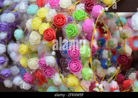 Closeup shot of colorful rubber mini roses attached on a spiral metal wire Stock Photo