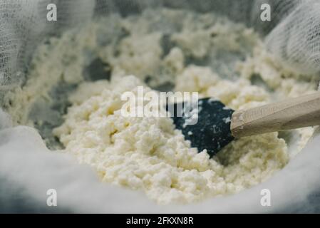 Strained ricotta cheese in a cheesecloth Stock Photo