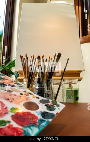 Color palette centered in vertical image whit brushes and white canvas Stock Photo