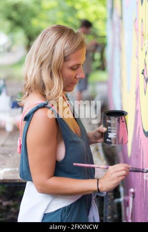 Side view of woman painting Stock Photo