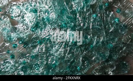 Pile of smashed plastic bottles laying on the floor landscape flat lay Stock Photo