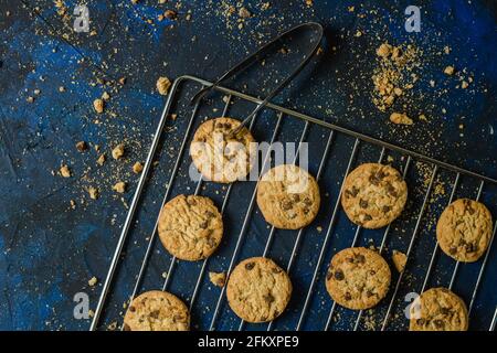 baked cookies on a blue textured surface with cookie crumbs Stock Photo