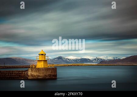 Long exposure of the yellow lighthouse named Nordurgardi at Reykjavik harbour in Iceland. Stock Photo