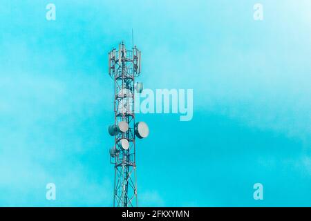 Mobile techology telecommunications network tower on a background of blue sky. Stock Photo