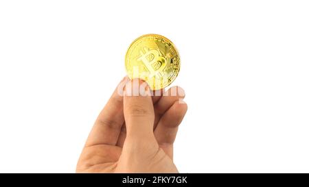 One bitcoin in hand isolated on white background, concept of cryptocurrency payment and transfers, cryptocurrency gold coin photo Stock Photo