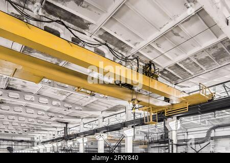 Overhead construction equipment crane in an industrial plant, background production workshop. Stock Photo