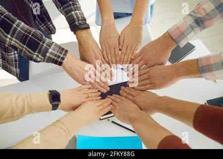 Young people group make shape of circle from palms joining together top view Stock Photo