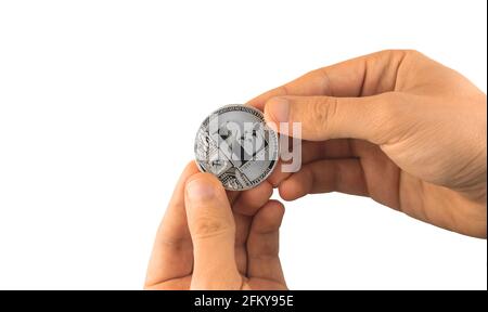 Silver litecoin cryptocurrency in male hands isolated on the white background Stock Photo