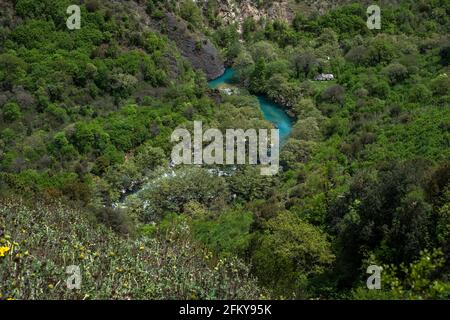 Voidomatis is one of the smallest but most beautiful rivers in Greece. Abandoned orthodox church next to river and forest. Stock Photo