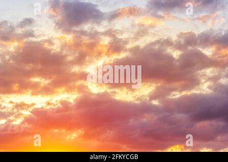 Sunset sky with clouds and sunbeams through wind clouds.  Stock Photo