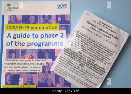 Covid-19 NHS vaccination programme leaflets on light blue background. Stock Photo