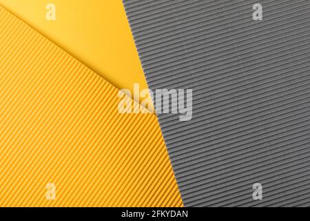 Yellow and gray corrugated paper texture. Geometric shapes and lines. Minimalist background. Flat lay. Copy space. Stock Photo