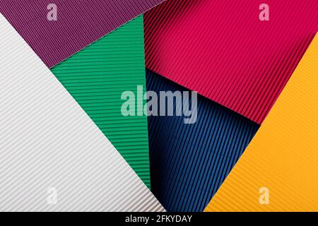 Colored corrugated paper texture. Geometric shapes and lines. Minimalist background. Flat lay. Copy space. Stock Photo