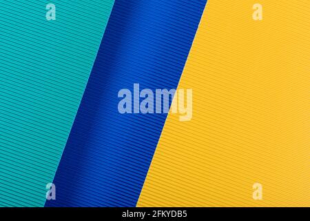 Yellow and blue corrugated paper texture. Geometric shapes and lines. Minimalist background. Flat lay. Copy space. Stock Photo