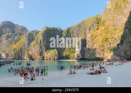 Phi Phi, Thailand - February 19 2014: Tourists visiting the popular sandy beach of Maya Beach on Ko Phi Phi Lee in the Phi Phi islands on the Andaman Stock Photo