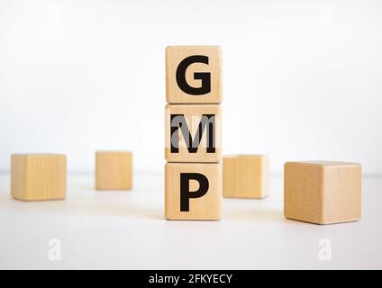 GMP, good manufacturing practice symbol. Concept words 'GMP, good manufacturing practice' on cubes on a beautiful white background. Business and GMP, Stock Photo