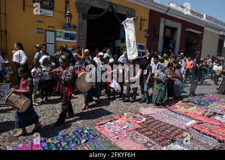 Intricate and vibrant sawdust alfombras decorate the cobblestone streets of Antigua, Guatemala in preparation for the Semana Santa processions. Stock Photo