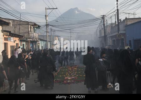 Intricate and vibrant sawdust alfombras decorate the cobblestone streets of Antigua, Guatemala in preparation for the Semana Santa processions. Stock Photo