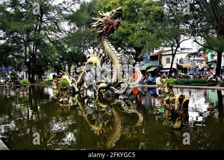 Urban park with pond and dragon fountain sculpture, Chinatown, Ho Chi Minh City, Vietnam, Asia
