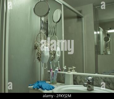 mask and gloves hanging in bathroom Stock Photo