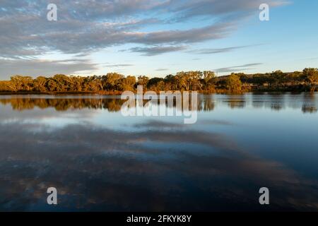 Scenic view of dramatic clouds reflected in Lake Inverell in late afternoon sunlight, Inverell, New South Wales, Australia Stock Photo