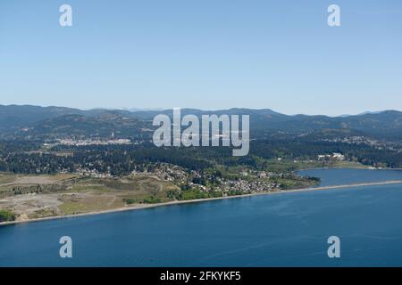 Aerial photo of the gravel pit and Esquimalt Lagoon and Colwood. Royal Roads University is located at the back of the lagoon, Vancouver Island, Britis Stock Photo