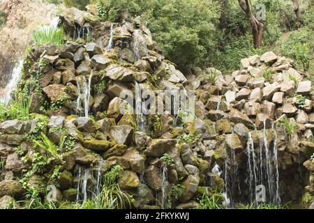 small waterfall flowing between the rocks in the forest Stock Photo