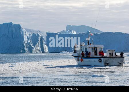 Tours amongst icebergs calved from the Jakobshavn Isbræ glacier, UNESCO World Heritage site, Ilulissat, Greenland. Stock Photo