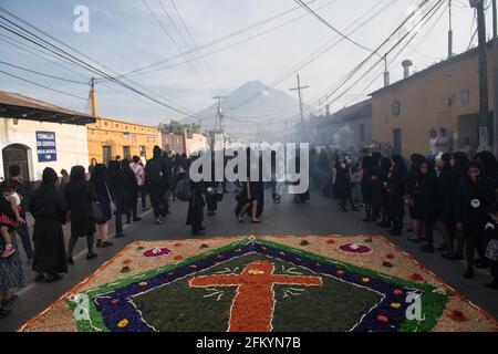 Intricate and vibrant sawdust alfombras decorate the cobblestone streets of Antigua, Guatemala in preparation for the Semana Santa processions. Stock Photo