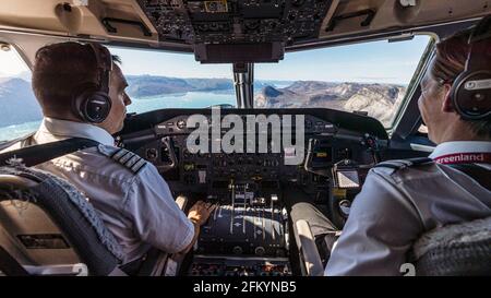 Pilots in the cockpit of a small prop plane, flying over Southwestern Greenland Stock Photo