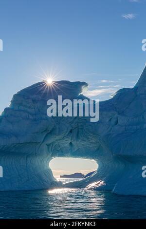 Sunburst on iceberg in De Dødes Fjord, Fjord of the Dead, Baffin Bay, Greenland. Stock Photo