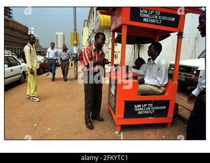 Daily life on the streets of Kampala Uganda Scratch and win cards are sold on every street Stock Photo