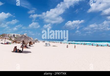 People sunbathing on Dolphin Beach by the Caribbean Sea, Cancun, Mexico. Stock Photo