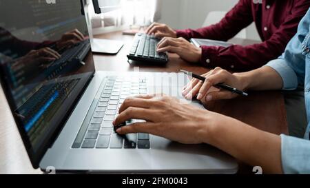 Team of Programmer working to find solution to problem and coding technologies in a software developing company office Stock Photo
