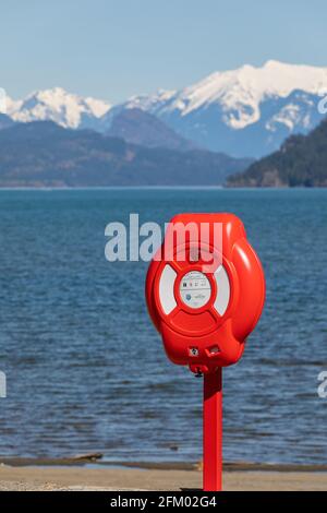 Guardian Lifebuoy at the beautiful blue lake and mountains background. Concept of the photo tourism, insurance, security Stock Photo