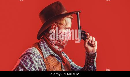 Portrait of a cowboy. West, guns. Portrait of a cowboy. American bandit in mask, western man with hat. Portrait of cowboy in hat Stock Photo